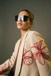 Close-Up of Red Embellishments on Beige Blazer